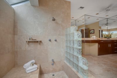 Refresh in a serene bathroom retreat with a glass block shower and modern vanity KBV-34G4