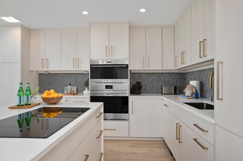 The island’s quartz counter sparkles like mermaid treasure, holding oranges and sparkling water like honored guests