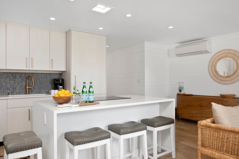 This kitchen gleams like a sun-kissed seashell—pale, polished, and filled with delicious seaside potential