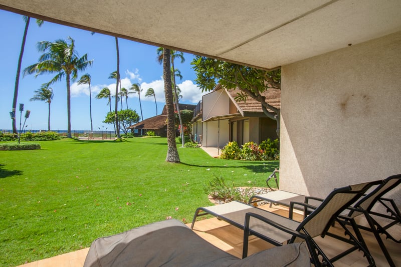 The lawn rolls out like a green welcome mat, leading you from your lanai to a sea of palm trees and salty breezes