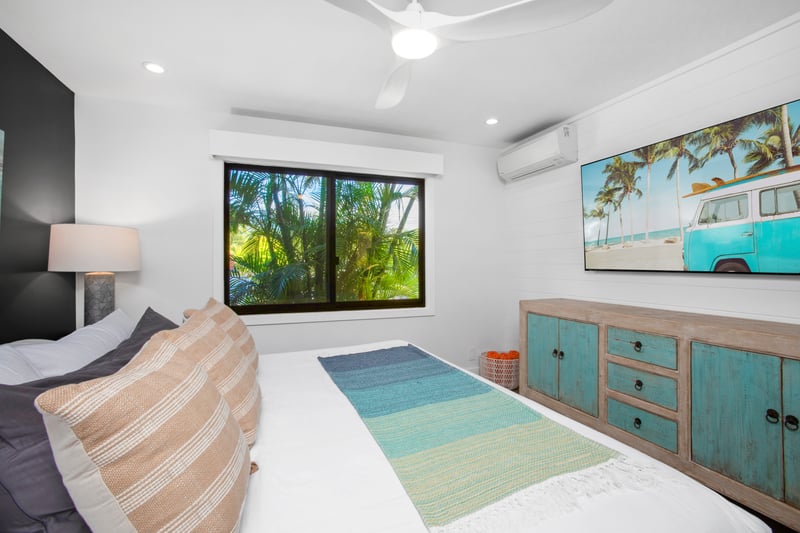 Stretch out like royalty in the king-sized bed, framed by plush pillows and kissed by tropical sunlight daily