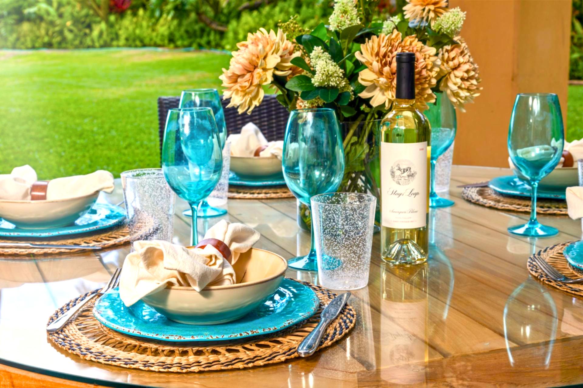 Where brunch meets paradise: toast with turquoise glassware and fresh blooms in a lush garden escape by the sea