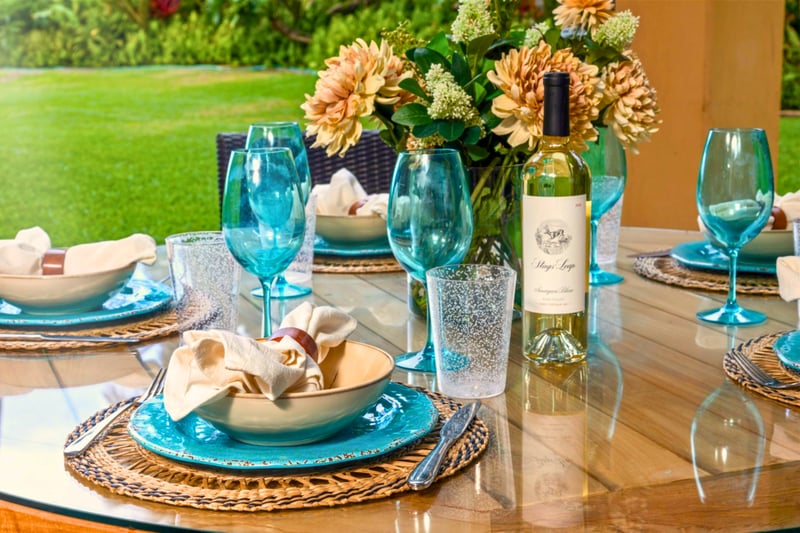 Where brunch meets paradise: toast with turquoise glassware and fresh blooms in a lush garden escape by the sea