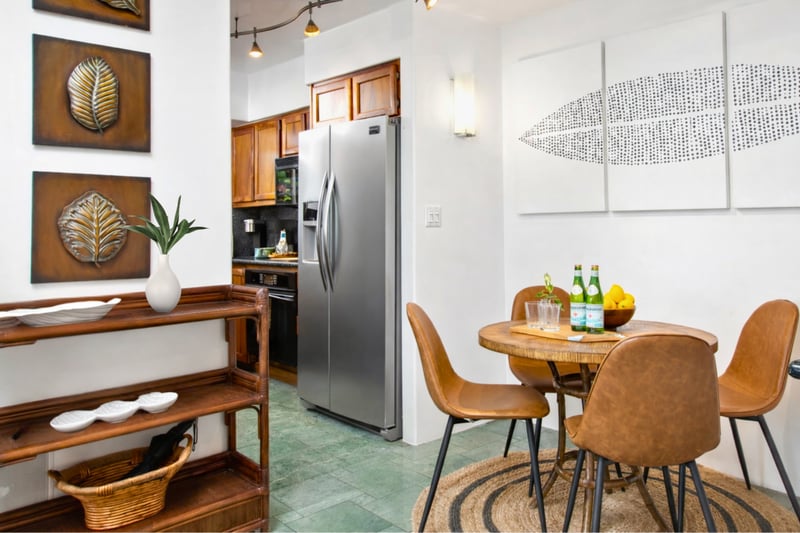 The open-concept dining area features stylish seating and elegant island décor, perfect for enjoying meals with friends and family.
