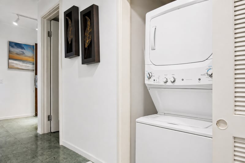 In-unit stacked washer and dryer at Polo Beach Club 109 for effortless laundry during your stay.