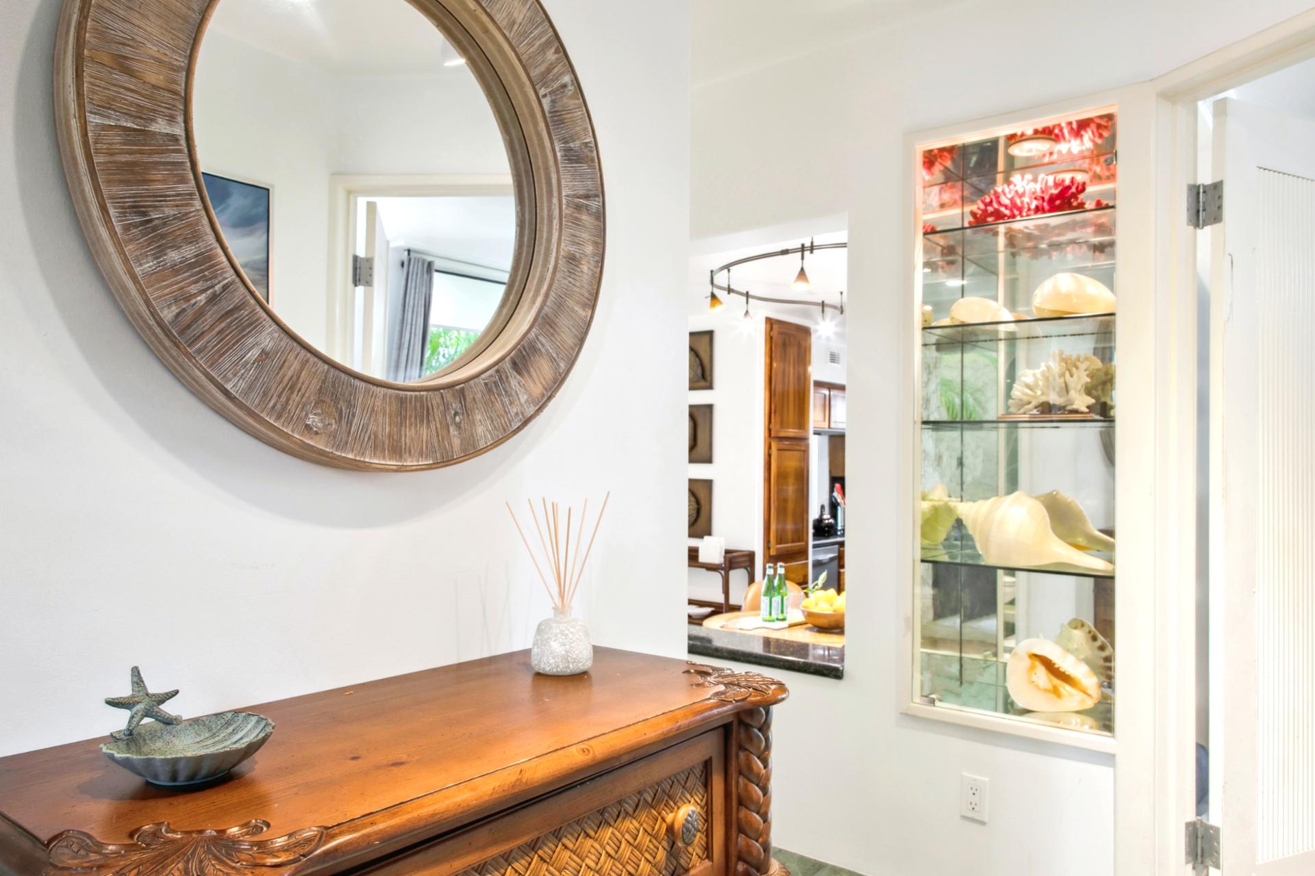 Step into your island escape through a beautifully maintained entrance surrounded by lush landscaping and welcoming touches.

