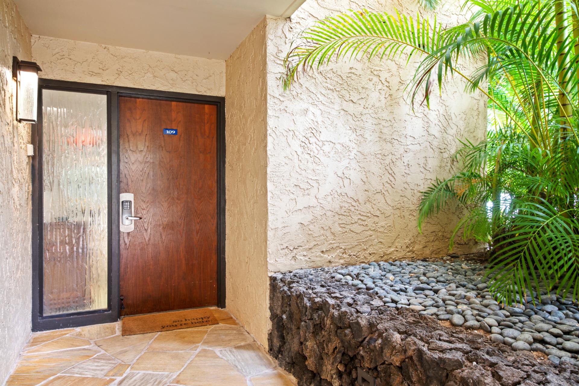 Step into your island escape through a beautifully maintained entrance surrounded by lush landscaping and welcoming touches.


