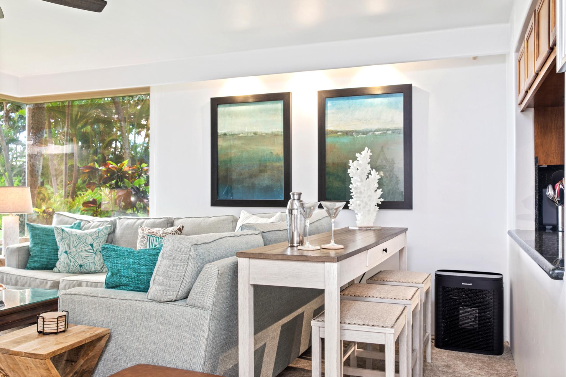 Spacious and light-filled living areas offer plush seating, ceiling fans, and large windows with garden views—ideal for relaxing after a day in the sun.