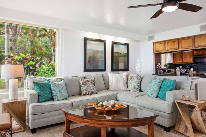 Spacious and light-filled living areas offer plush seating, ceiling fans, and large windows with garden views—ideal for relaxing after a day in the sun.