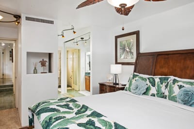Elegant wood-carved furnishings and natural light-filled space create the perfect sanctuary for restful island nights