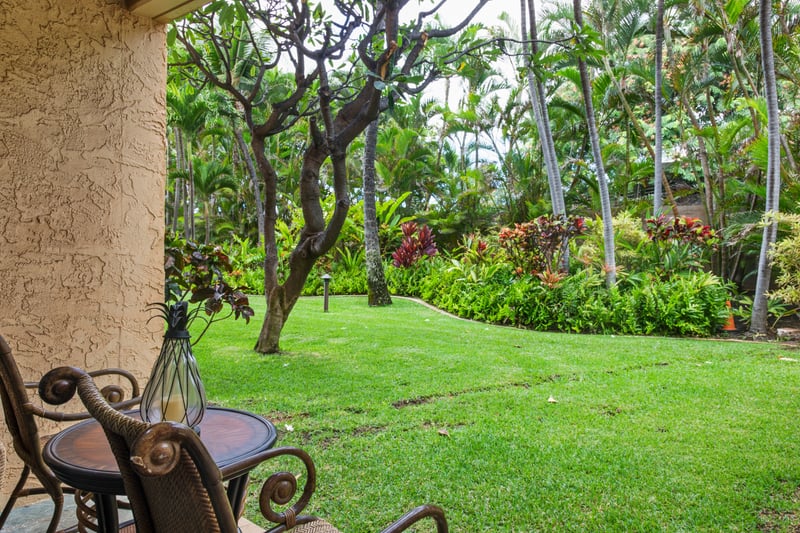 A space that lives between indoors and out—earth-toned walls, cool stone tiles, and the soft sway of palm fronds