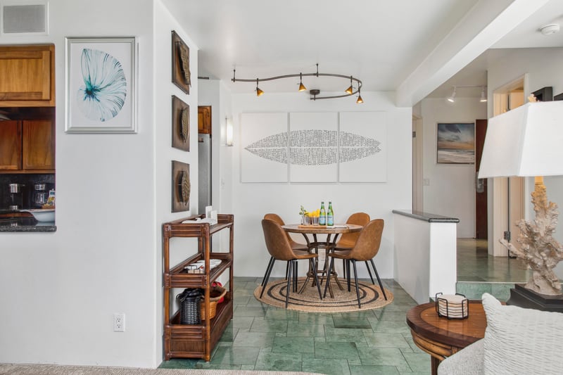 The open-concept dining area features stylish seating and elegant island décor, perfect for enjoying meals with friends and family.

