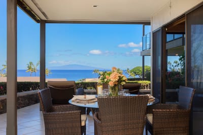 This lanai doesn't just overlook the ocean—it connects you to it, with every breeze echoing 'Aloha'