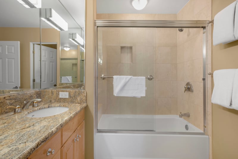 Granite countertops ripple like caramel swirls in a latte, offering a sweet stage for morning routines and moonlit masks
