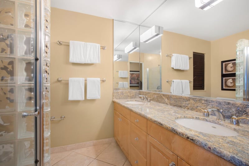 A sea of smooth granite stretches across the double vanity, offering space for both your toothpaste and your treasures