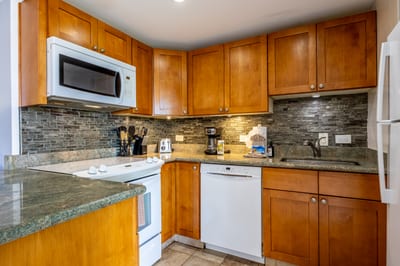 Cook up island-inspired meals in a fully equipped kitchen featuring granite countertops and modern appliances.