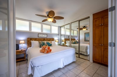 Retreat to a serene bedroom with mirrored closets, coastal decor, and plush bedding for restful nights.