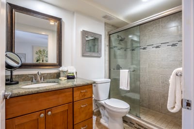 Refresh in a stylish bathroom with a walk-in glass shower and spa-inspired finishes.