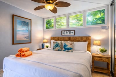 The tranquil bedroom features tropical accents and natural light—your cozy haven after a day at the beach.
