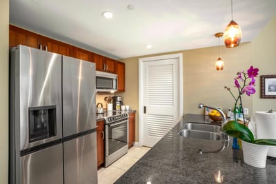 Modern kitchen with granite countertop and stainless steel appliances. HKH-114