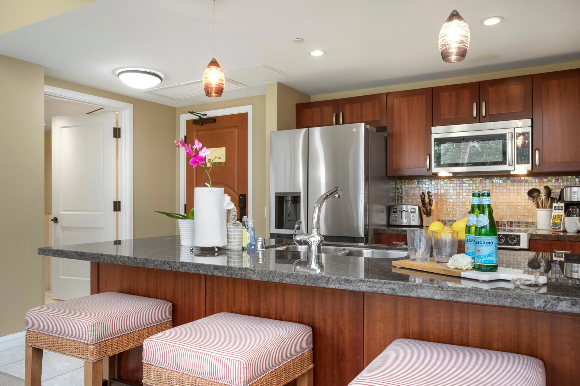 Stylish gourmet kitchen with granite countertops, stainless steel appliances, and bar seating.