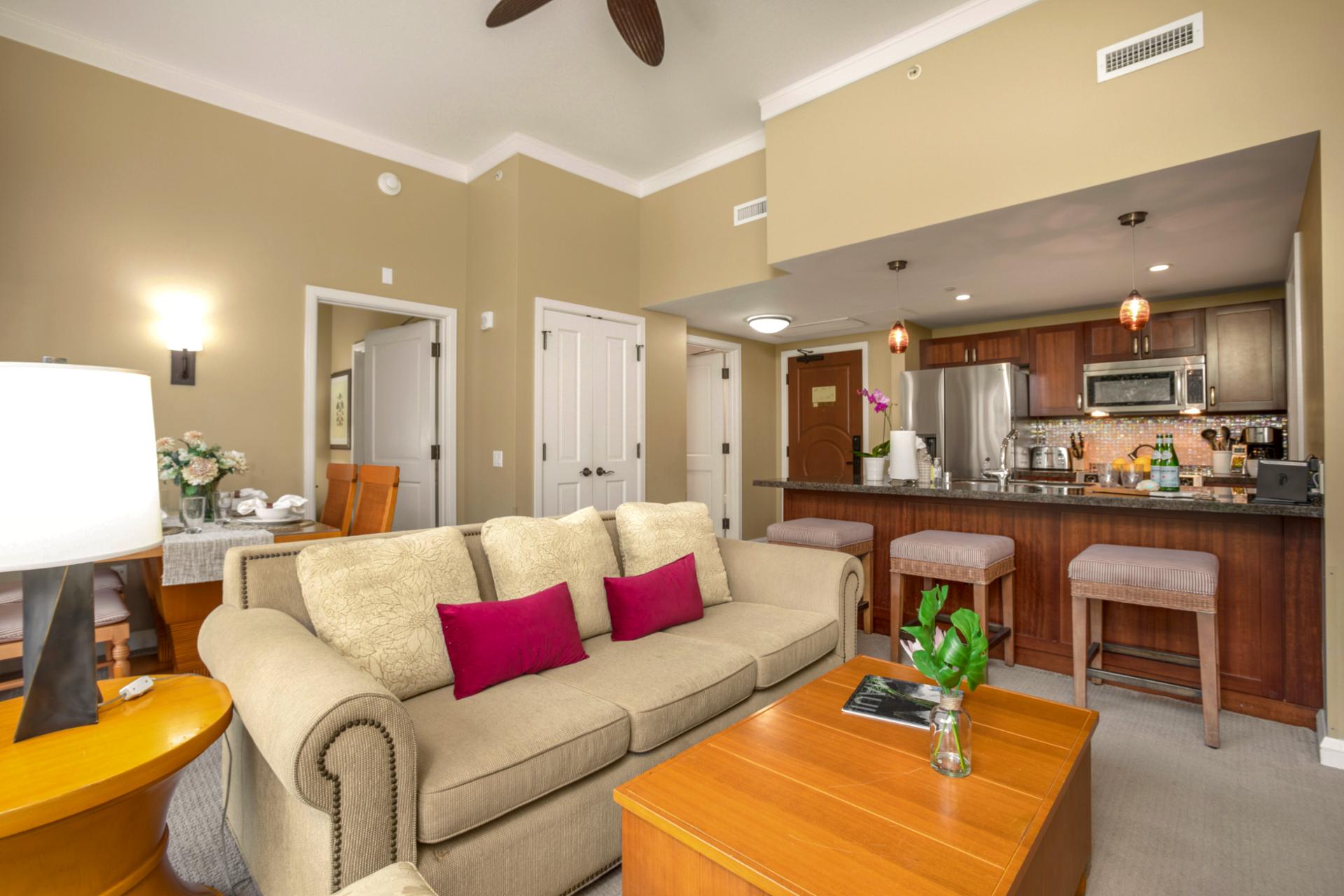 Open-concept living area featuring direct access to the patio, natural light, and a tropical ambiance