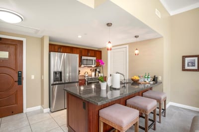 Stylish gourmet kitchen with granite countertops, stainless steel appliances, and bar seating HKH-114