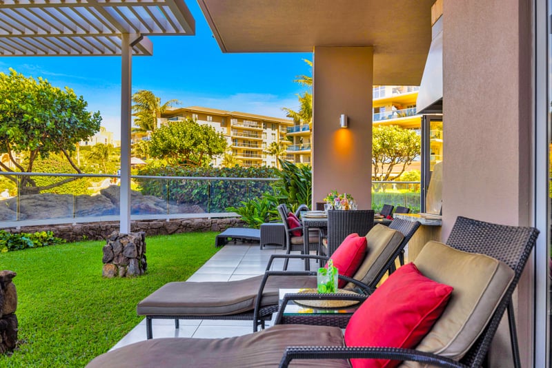 Bistro dining at Honua Kai HKH-150 — an intimate lanai table for two with wine and fresh flowers