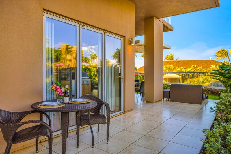 Sunset lanai dining at Honua Kai HKH-150 — an intimate table for two set with wine and fresh flowers