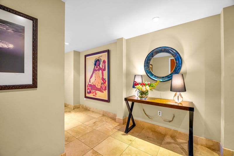 Entry hallway at Honua Kai HKH-150 — Hawaiian-inspired art and a console table welcome guests home