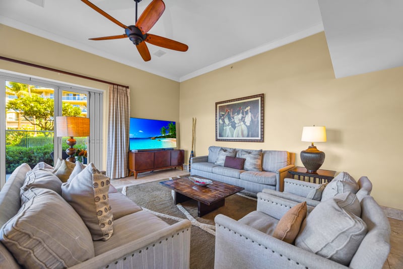 Living room at Honua Kai HKH-150 — Hawaiian-inspired art and a smart TV above cozy seating