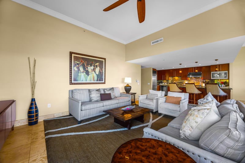 Living room at Honua Kai HKH-150 — Hawaiian artwork and open sightlines to the kitchen bar