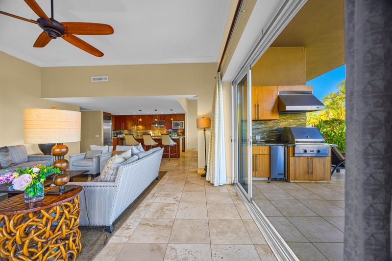 Open-concept living at Honua Kai HKH-150 — kitchen, living room, and lanai flow together for effortless entertaining