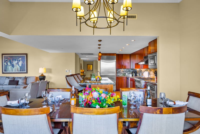Dining room at Honua Kai HKH-150 — table for ten with an open sightline to the Sub-Zero and Viking kitchen