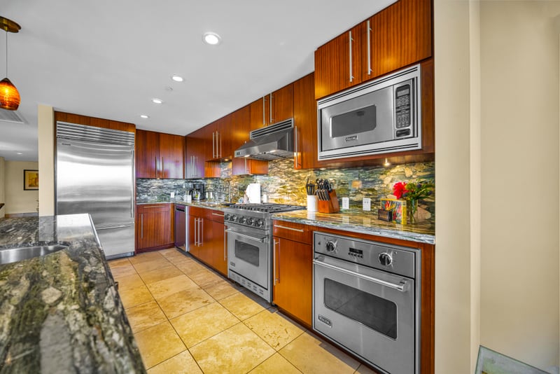 Chef's kitchen at Honua Kai HKH-150 — Sub-Zero refrigerator, Viking range, and marble backsplash