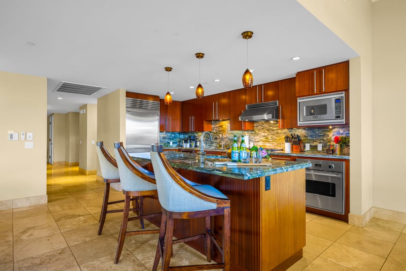 Kitchen island at Honua Kai HKH-150 — granite island seating for three with a built-in wine fridge
