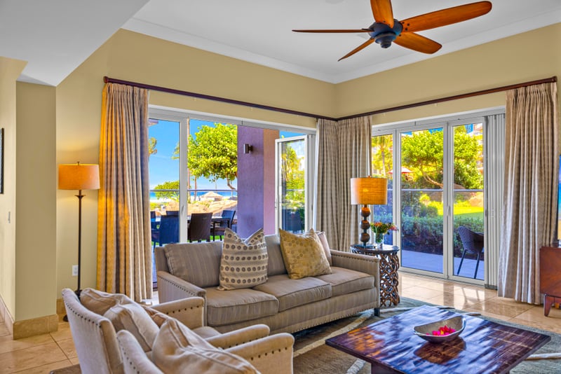 Living room at Honua Kai HKH-150 — comfortable seating opening directly onto sand and surf