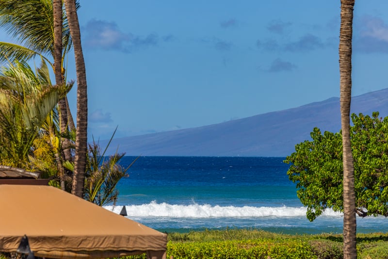 Oceanview at Honua Kai HKH-150 — Molokai visible on the horizon beyond the rolling surf