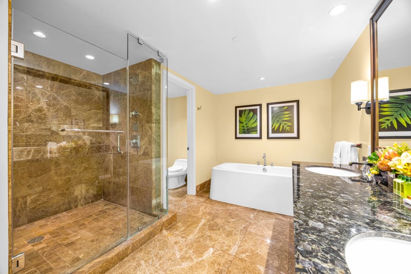 Primary bath at Honua Kai HKH-150 — spa-style shower and tub with a private water closet