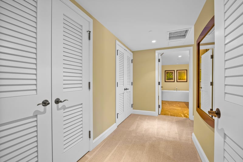 Guest suite hallway at Honua Kai HKH-150 — louvered closet doors leading to the ensuite bath