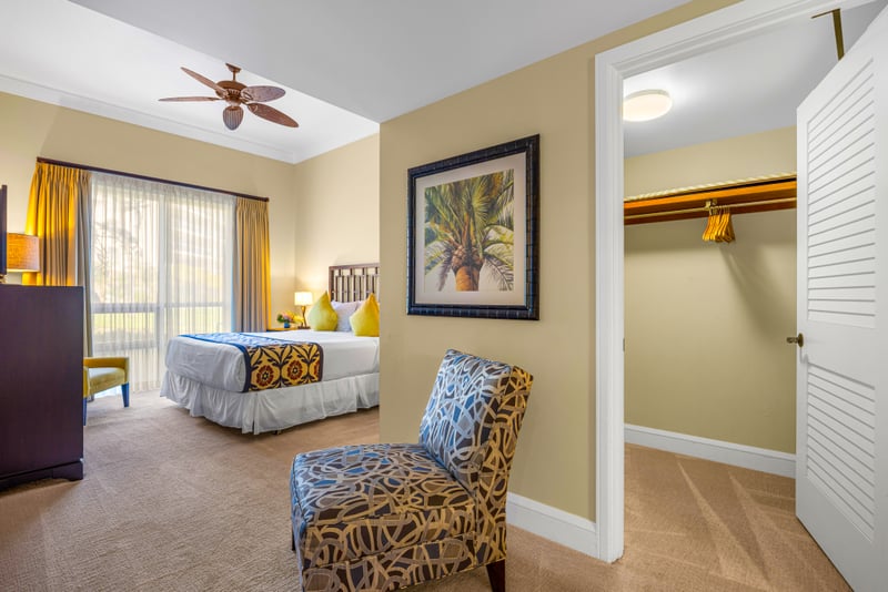 Guest bedroom at Honua Kai Hokulani 150 — queen bed, ceiling fan, and a spacious walk-in closet