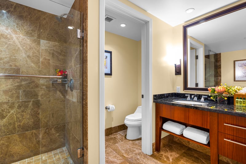 Guest bathroom at Honua Kai HKH-150 — glass-enclosed shower with a separate private water closet