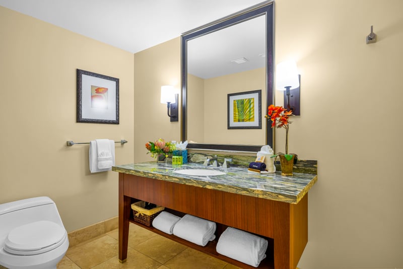 Guest bathroom at Honua Kai HKH-150 — glass shower door and coastal-inspired wall art