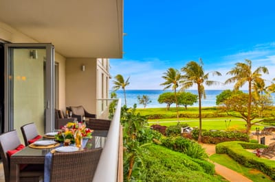 Tropical greenery and ocean glimpses create a tranquil backdrop from the private balcony.