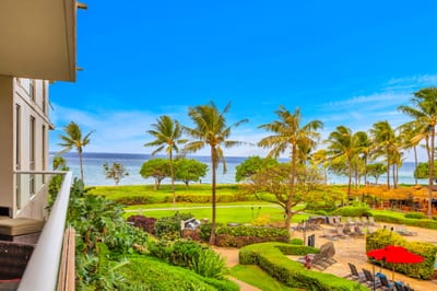 Lush landscaping and a glimpse of the sea set the tone for laid-back island living.