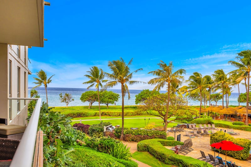 Lush landscaping and a glimpse of the sea set the tone for laid-back island living.