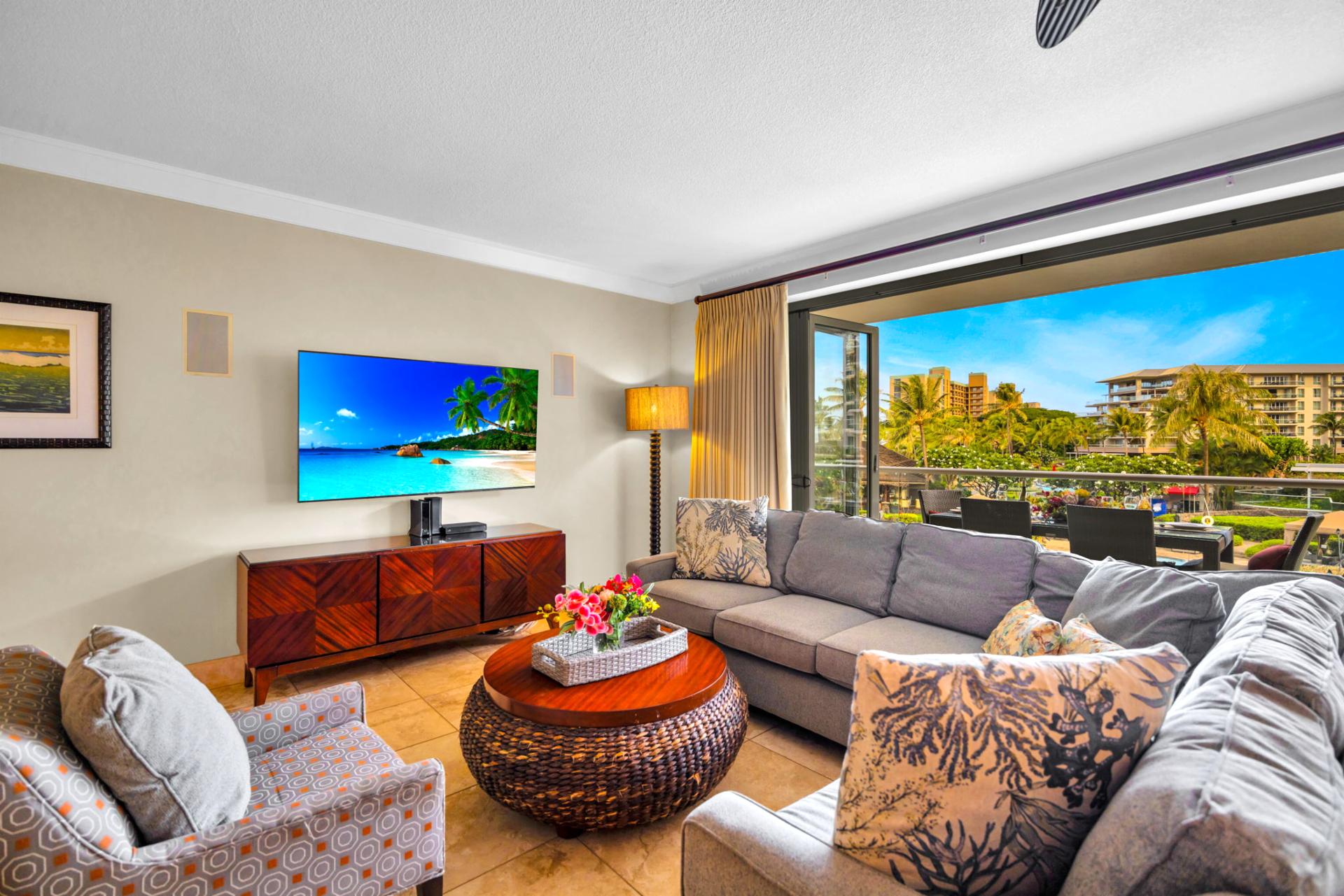 Bright and welcoming living area with a large Smart TV and sofa sleeper for extra sleeping space. HKH-203