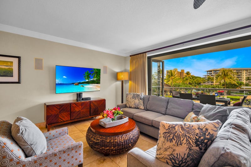 Bright and welcoming living area with a large Smart TV and sofa sleeper for extra sleeping space.