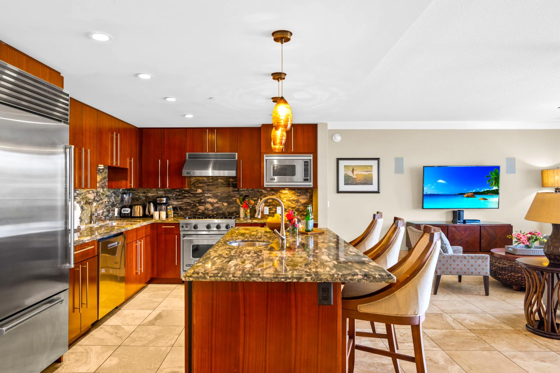 Warm wood cabinetry, stone countertops, and a wide prep island make cooking easy and social. HKH-203