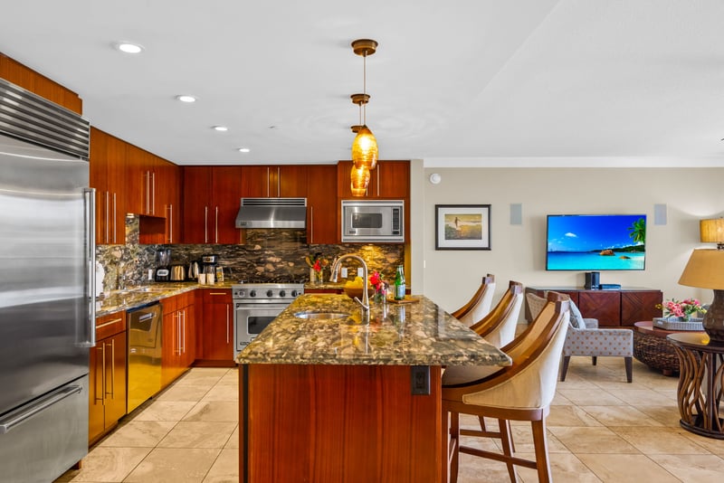 Warm wood cabinetry, stone countertops, and a wide prep island make cooking easy and social.